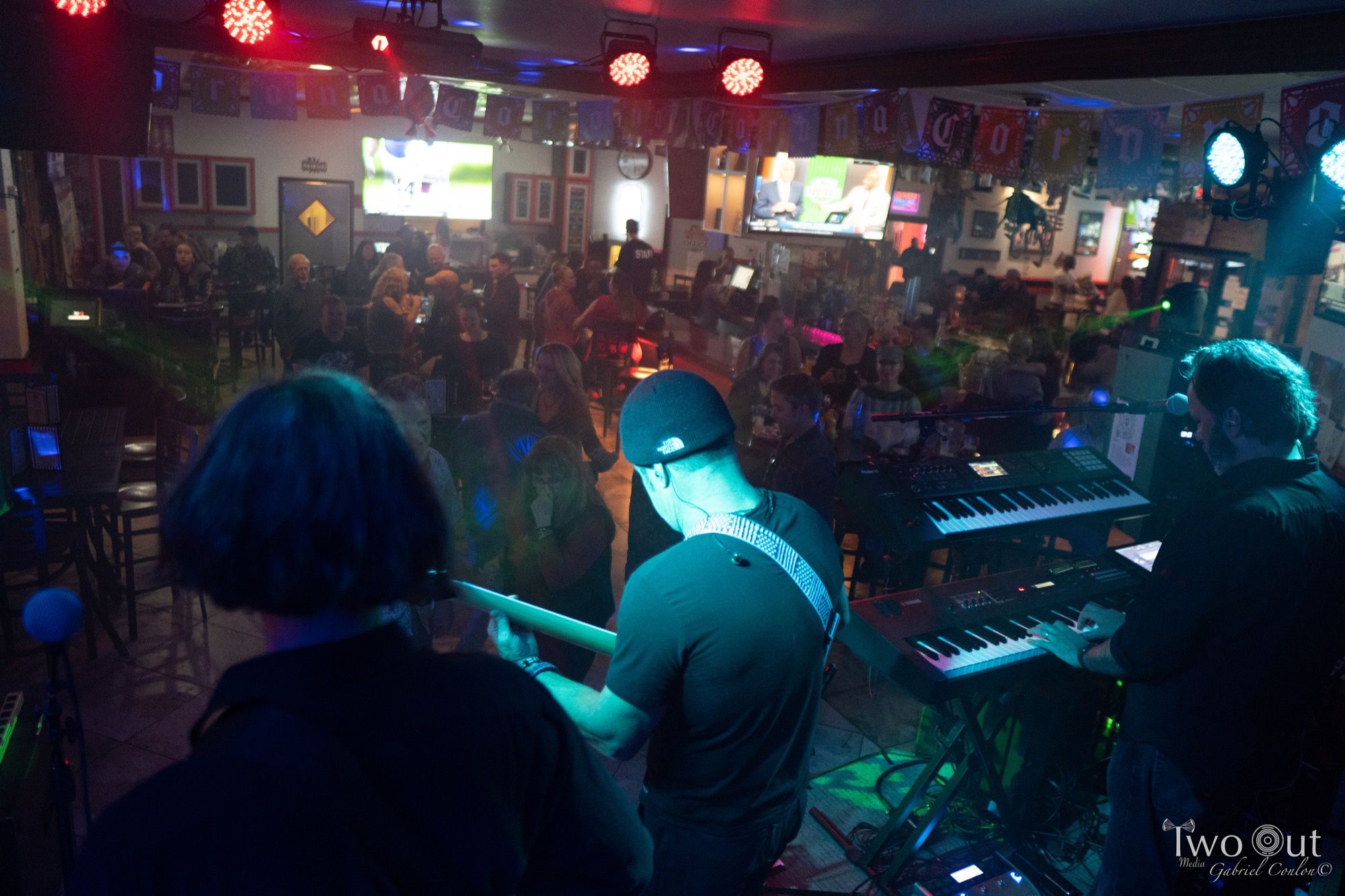 Keyboardists performing for a packed bar crowd at one of Last Patrol Band's regular Colorado Springs gigs