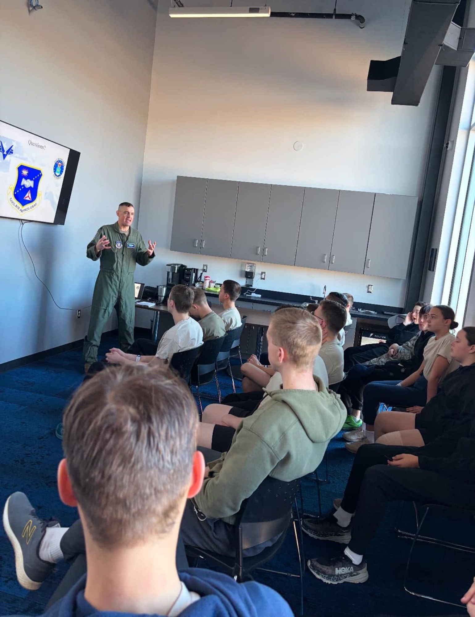 An instructor teaching a classroom of cadets about flight